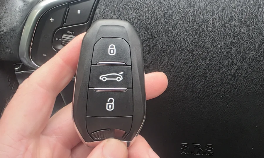 Vehicle key held in front of the dashboard